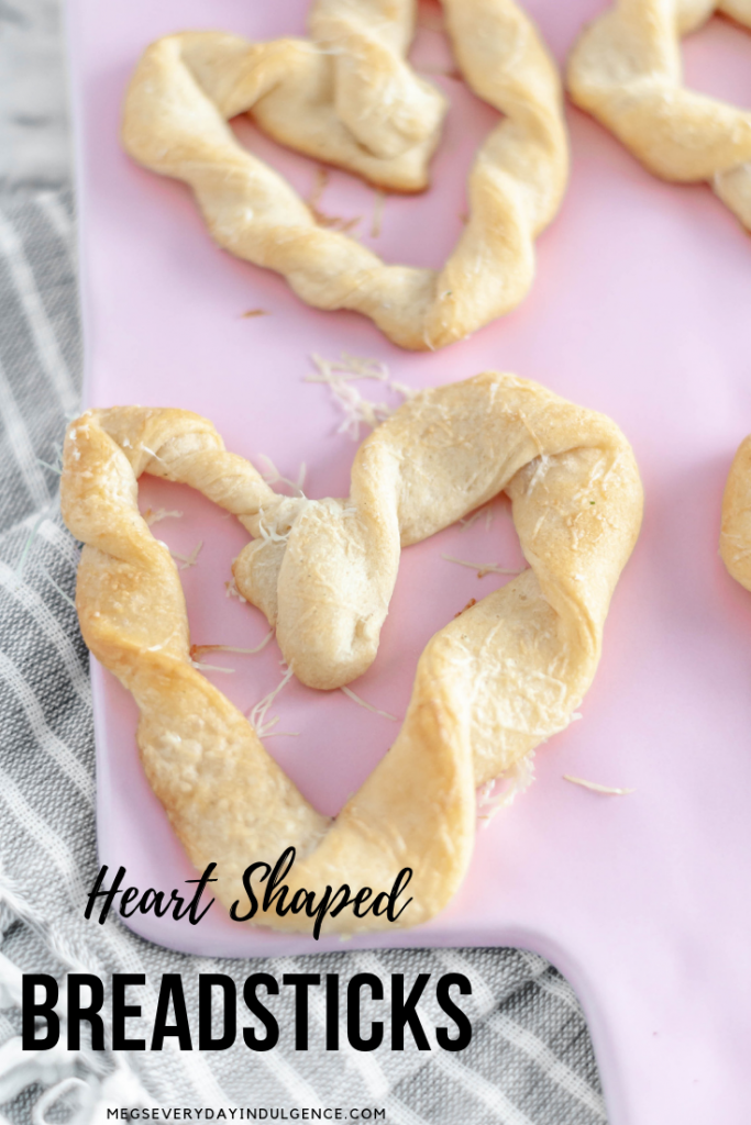 Heart Shaped Breadsticks are a simple way to add some festive flair to Valentines. Store-bought crescent dough & a few simple ingredients are all you need.