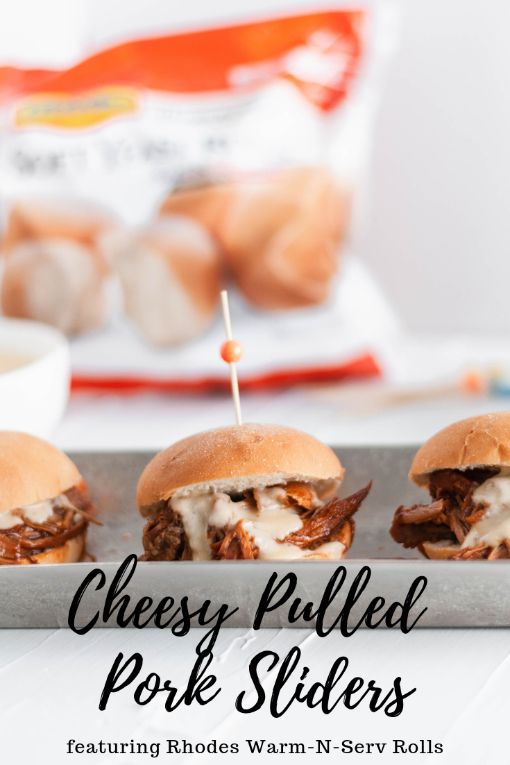 It's football season and that means we need all the delicious party food. Start the game off right with these Cheesy Pulled Pork Sliders. Slow cooker pulled pork, barbecue sauce and a rich, cheesy sauce all loaded atop a soft, pillowy Rhodes Warm-N-Serv roll.