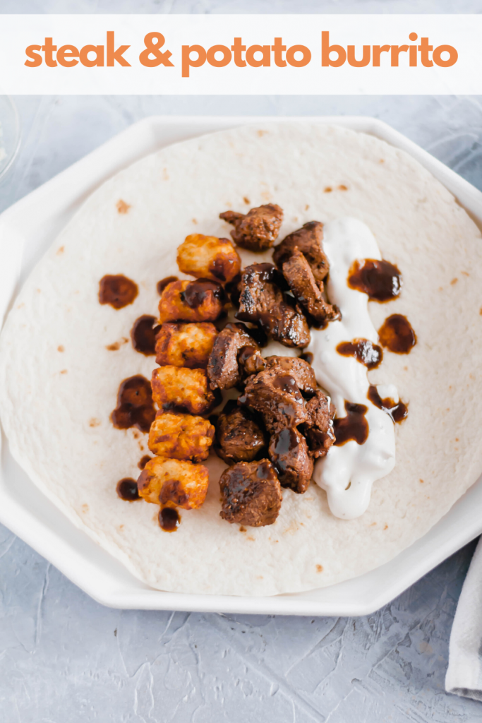 This Steak and Potato Burrito is stuffed with tender seared steak, crispy tater tots, blue cheese dressing and a drizzle of steak sauce. The perfect meal any time of the day.