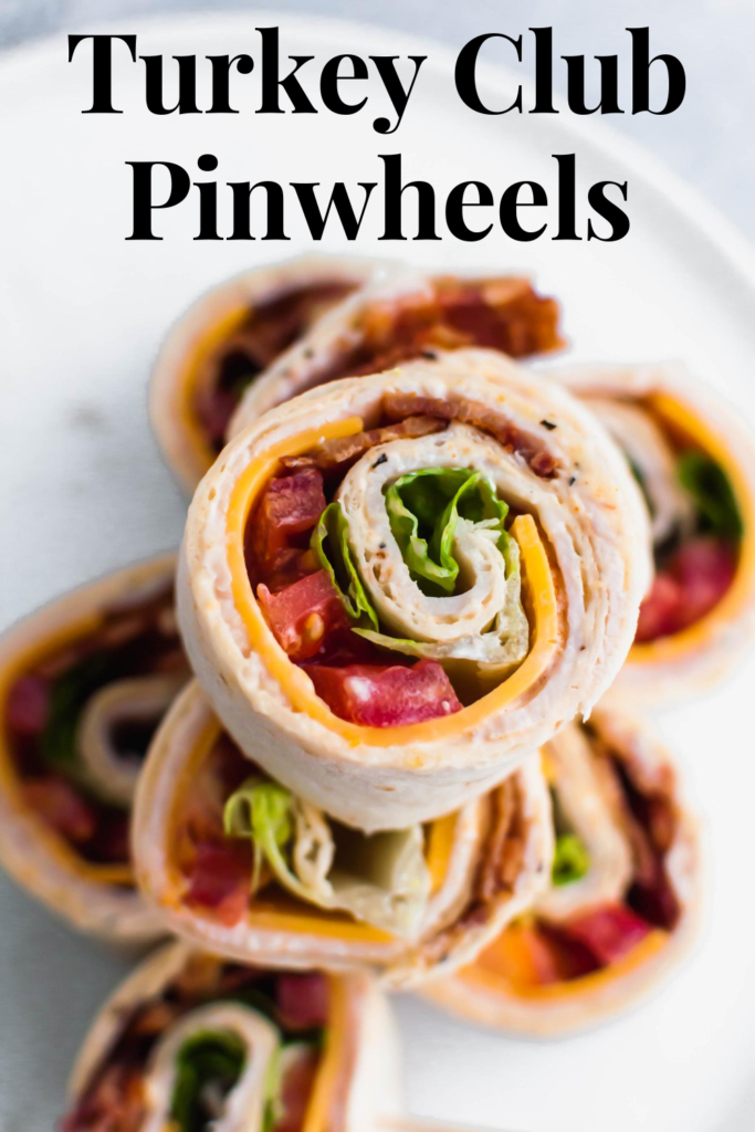 These Turkey Club Pinwheels turn the classic sandwich into a fun, bite-size appetizer. Great for parties or a fun lunch option. Spiced mayo, sharp cheddar cheese, deli turkey, bacon, lettuce and tomato make up these delicious pinwheels.