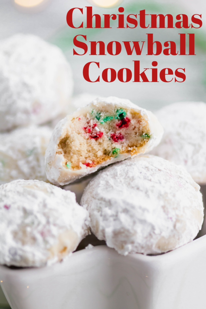 Tender, melt in your mouth Christmas Snowball Cookies are the perfect addition to your baking list this season. Super festive and fun.