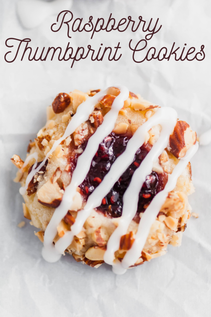 These Raspberry Thumbprint Cookies will quickly become your favorite Christmas cookie. Melt in your mouth cookies, rolled in chopped salted almonds, filled with raspberry jam and drizzled with glaze. The prettiest cookie to add to your Christmas cooking baking list