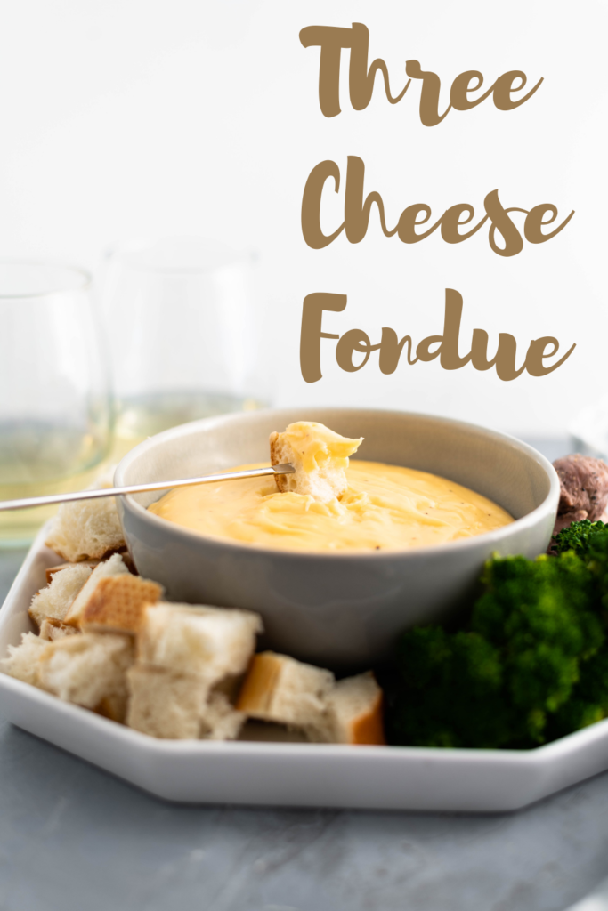 Three Cheese Fondue is perfect for the holidays. Creamy smoked gouda, sharp cheddar and fresh parmesan combine with garlic and white wine for a super fun appetizer or dinner. Use bread, steamed veggies, chicken and steak as dippers.