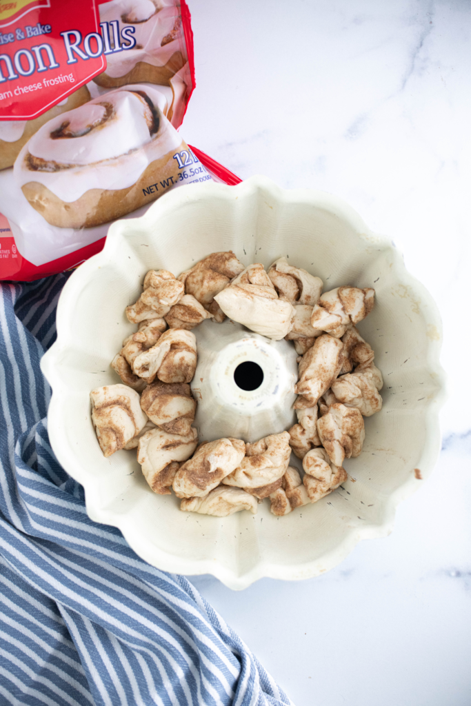 Cut up cinnamon roll dough in a bundt pan.