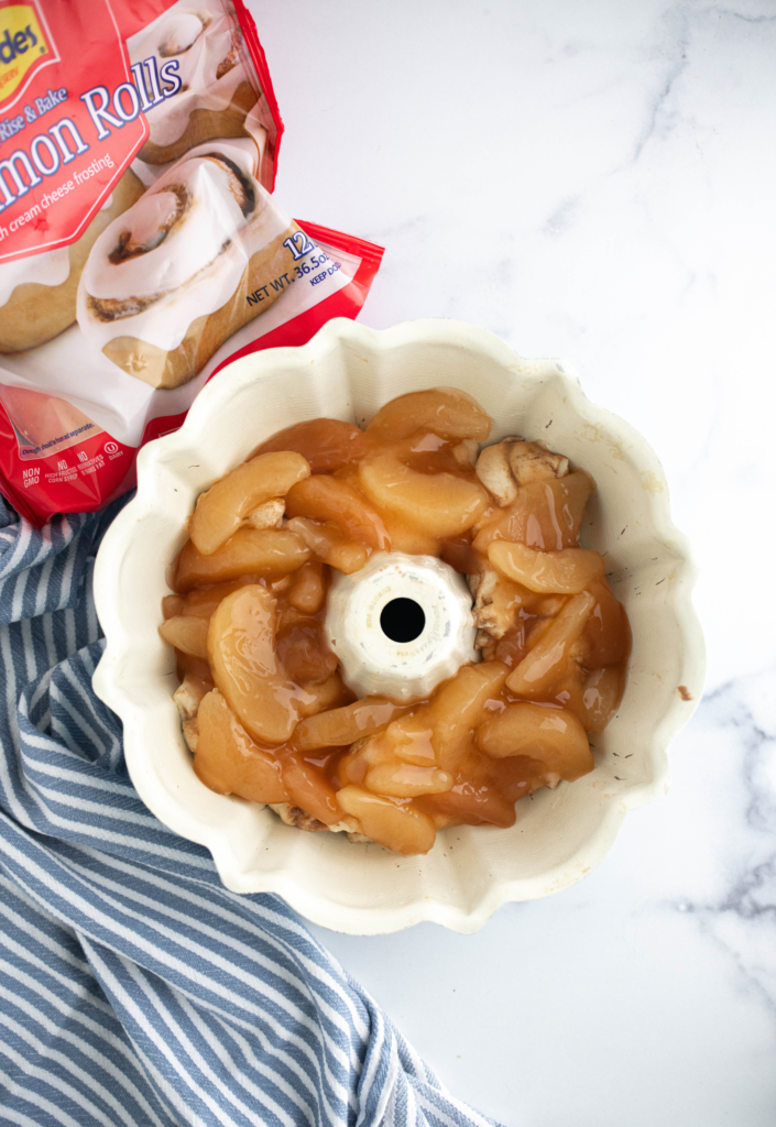 Cut up cinnamon rolls with apple pie filling spread over top in a bundt pan.