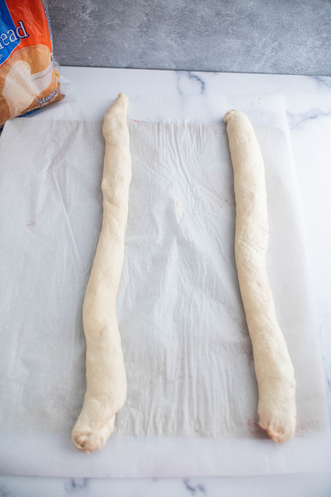 Two long rolled up pieces of bread dough.