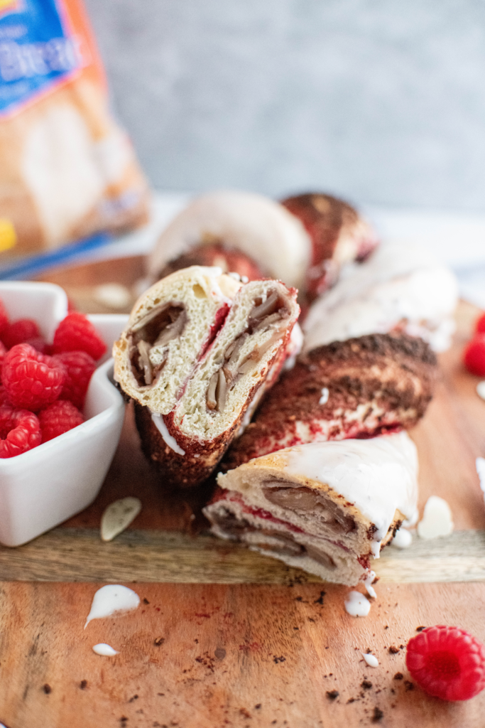 Candy Cane bread slice to show interior of raspberry preserves and sliced almonds.