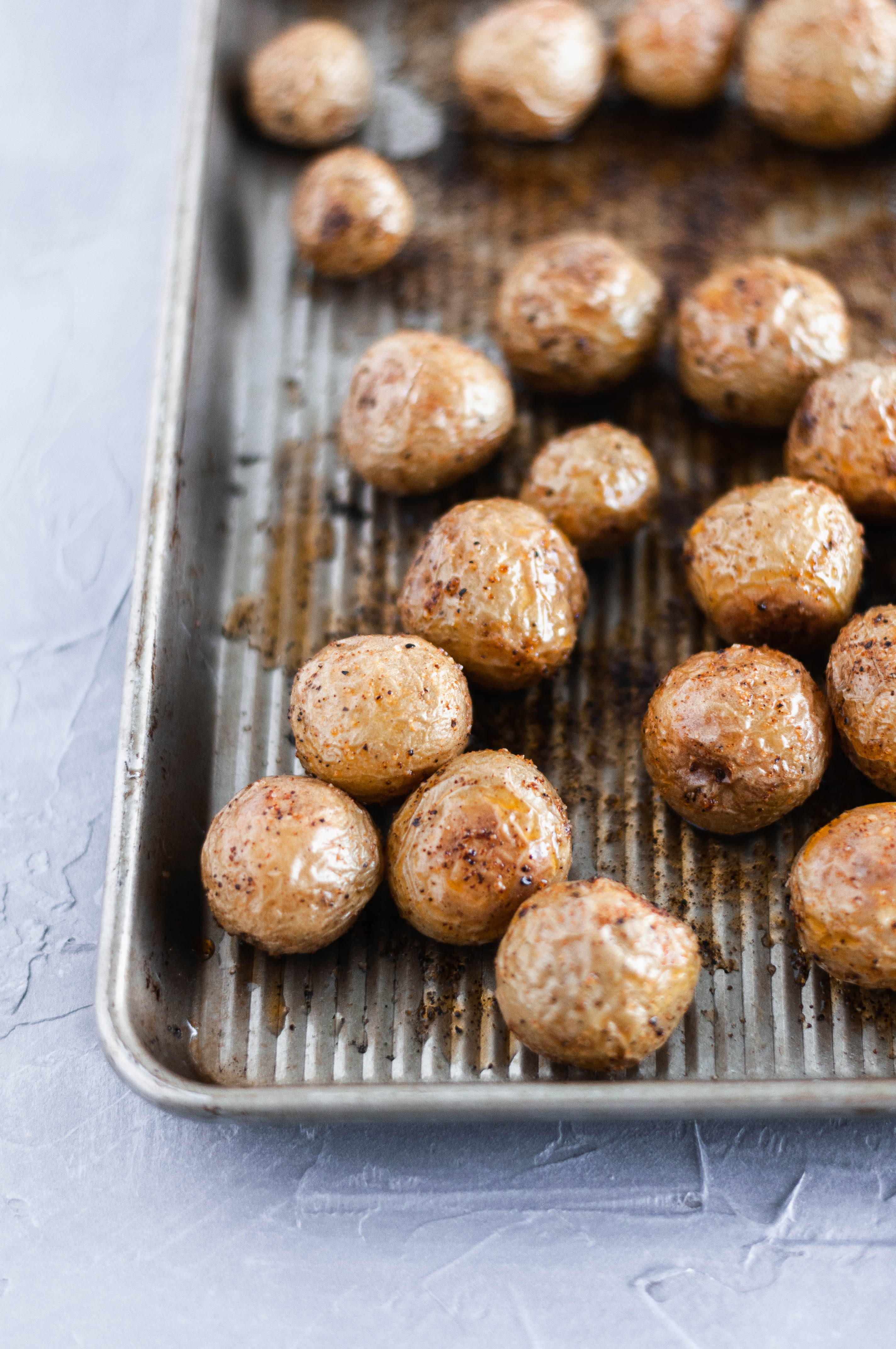 These Roasted Teeny Tiny Taters - a simple side dish using Trader Joe's teeny tiny taters. Only a handful of ingredients and 30 minutes needed.