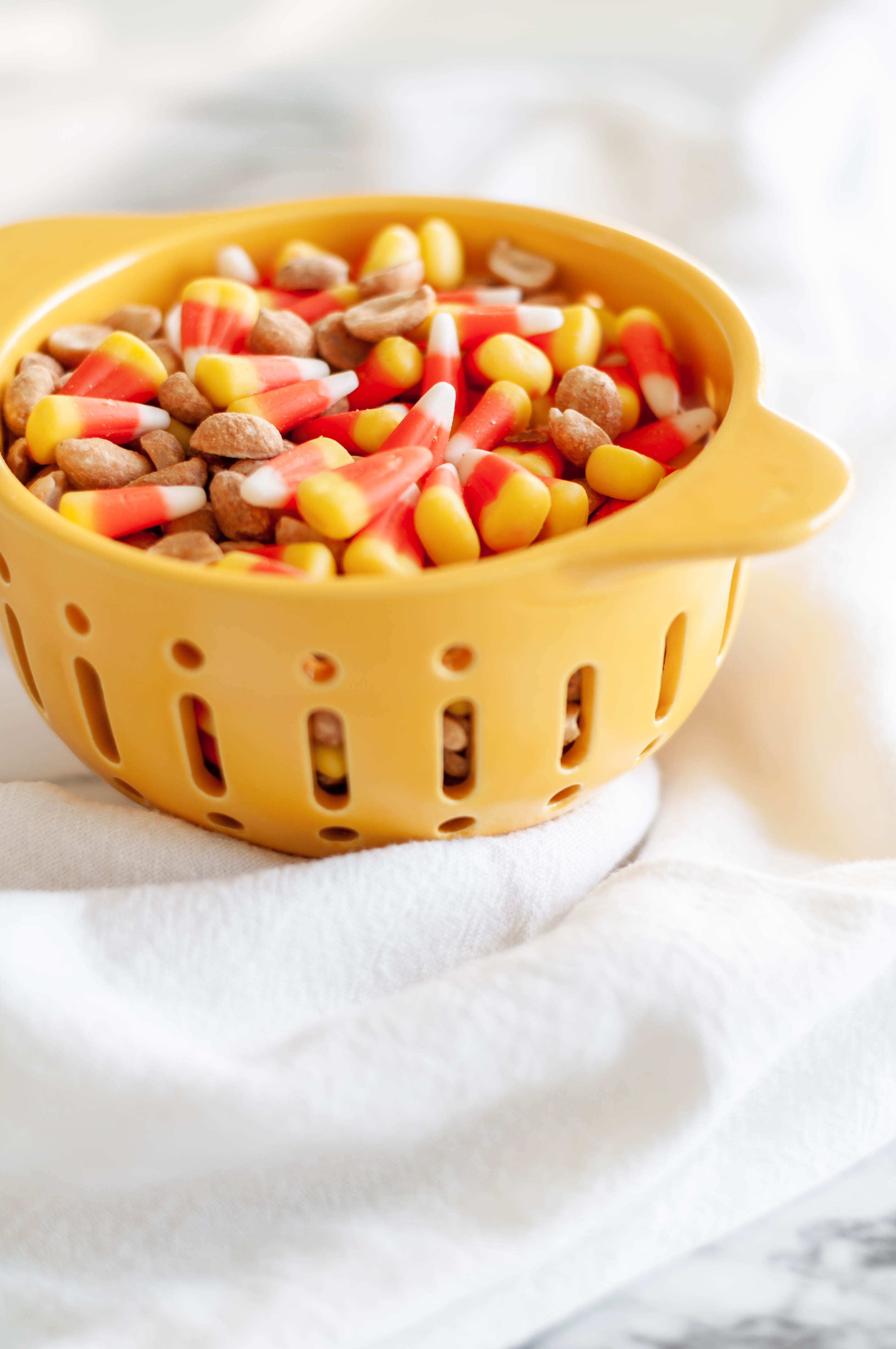 Candy Corn Mix is a simple mix of candy corn and dry roasted peanuts that makes the best sweet and salty treat. Tastes just like a Baby Ruth bar.