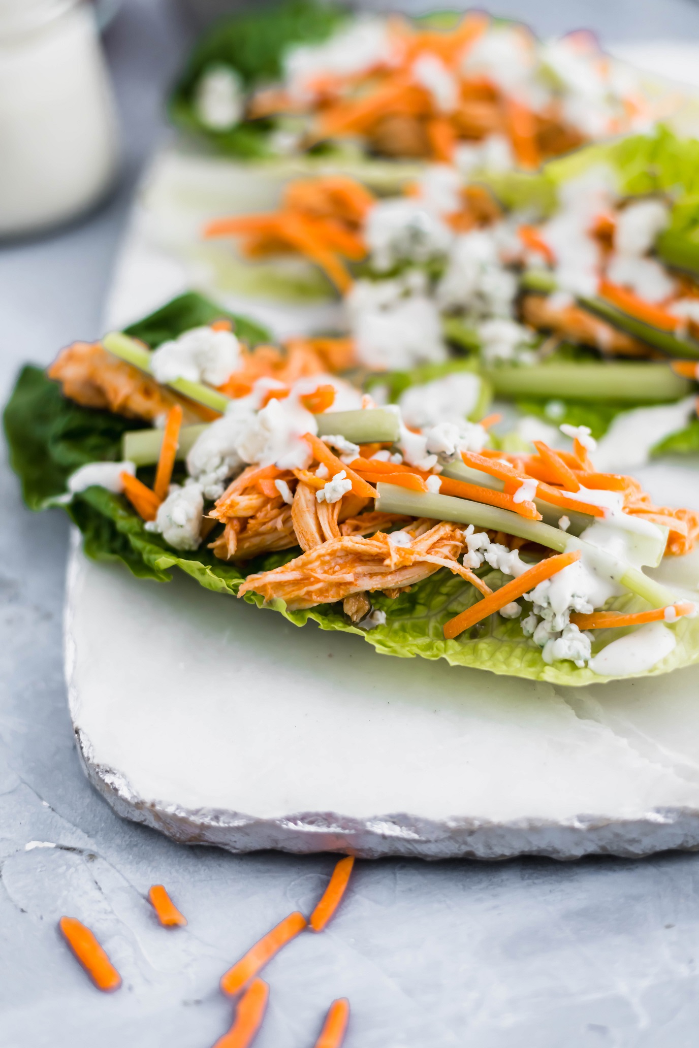 These Slow Cooker Buffalo Chicken Lettuce Wraps are super quick to get on the table. Slow cooker buffalo chicken, crisp romain leaves, celery, shredded carrot, blue cheese and ranch make a super quick, easy and healthy lunch or dinner. Perfect for meal prep.