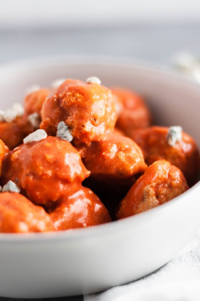 You NEED these Buffalo Chicken Meatballs for game day. Tender and spicy with a bite from the blue cheese.