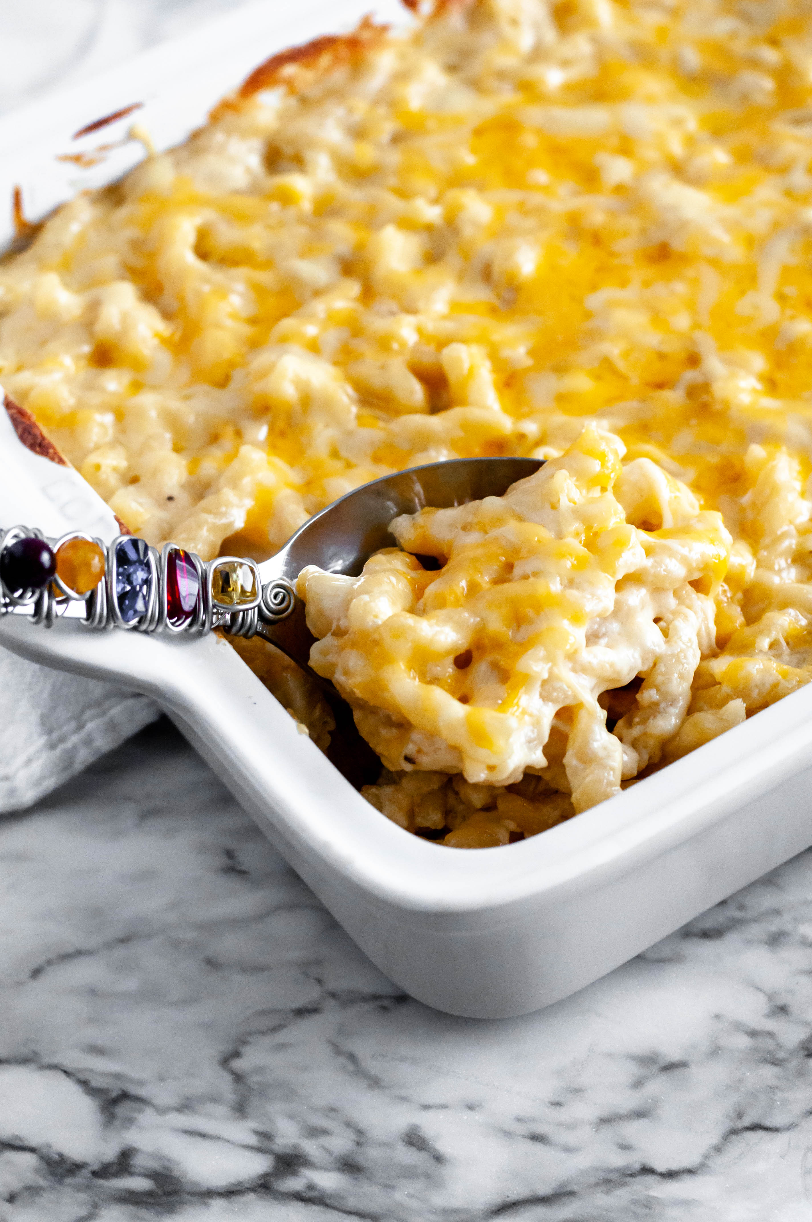 This creamy Smoked Gouda and Sharp Cheddar Macaroni and Cheese is the ultimate pasta dish. Smoky gouda and sharp cheddar make the most flavorful cheese sauce. Just what your holiday table needs.