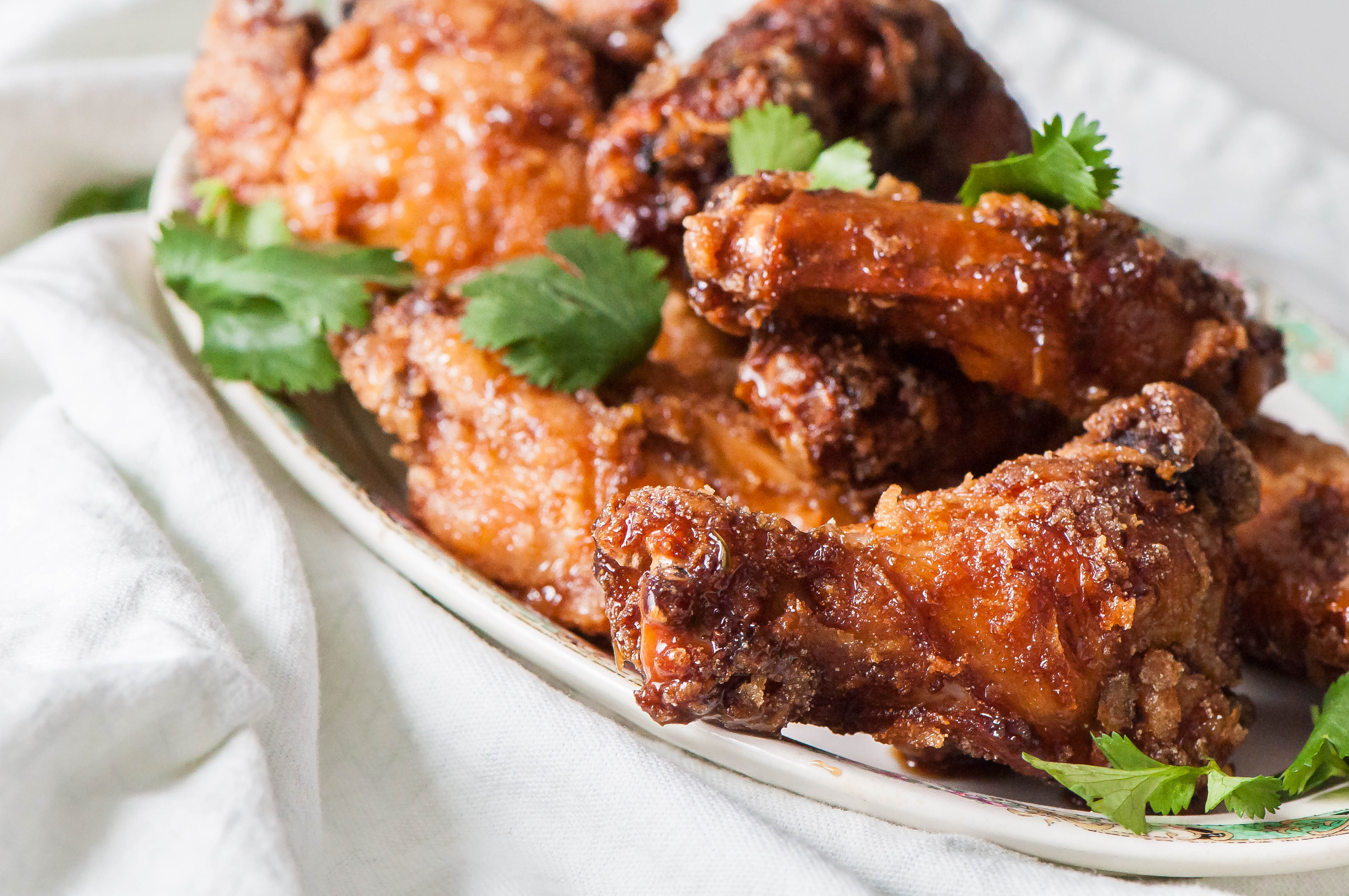 Thai Fried Chicken Wings are super crispy (and gluten free) from rice flour. Tossed in a delicious Thai sauce.