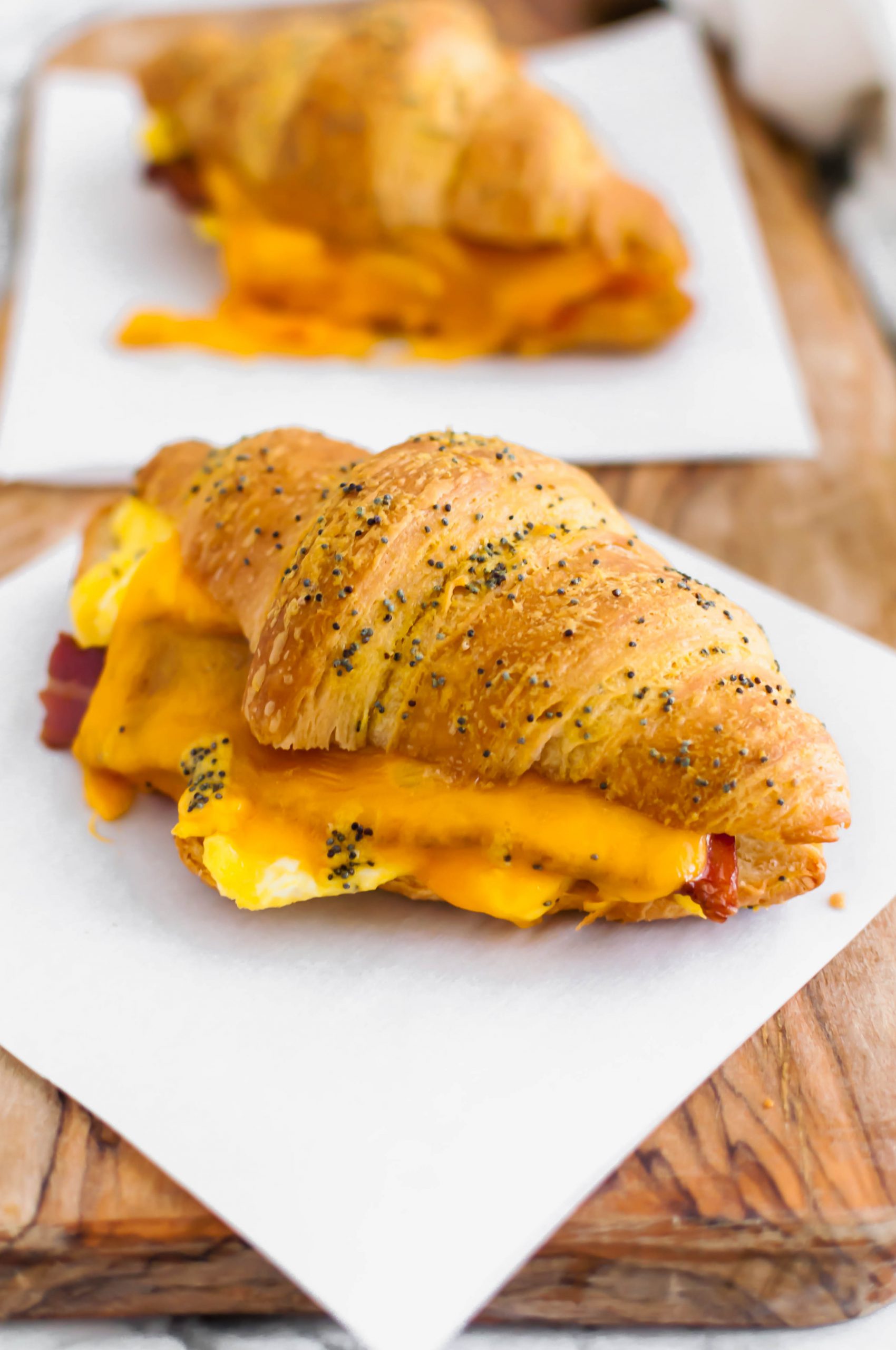 These Baked Breakfast Croissant Sandwiches start with a buttery, flaky croissants and are filled with scrambled eggs, crisp bacon and melted cheddar cheese to create a delicious hand held breakfast to enjoy at home or on the go.