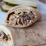 Cuban Wraps are a twist on a classic sandwich of roasted pork, deli ham, Swiss cheese, pickle & mustard. Made in the slow cooker for a simple weeknight meal