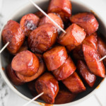 BBQ Kielbasa Bites in a gray bowl with toothpicks in them.