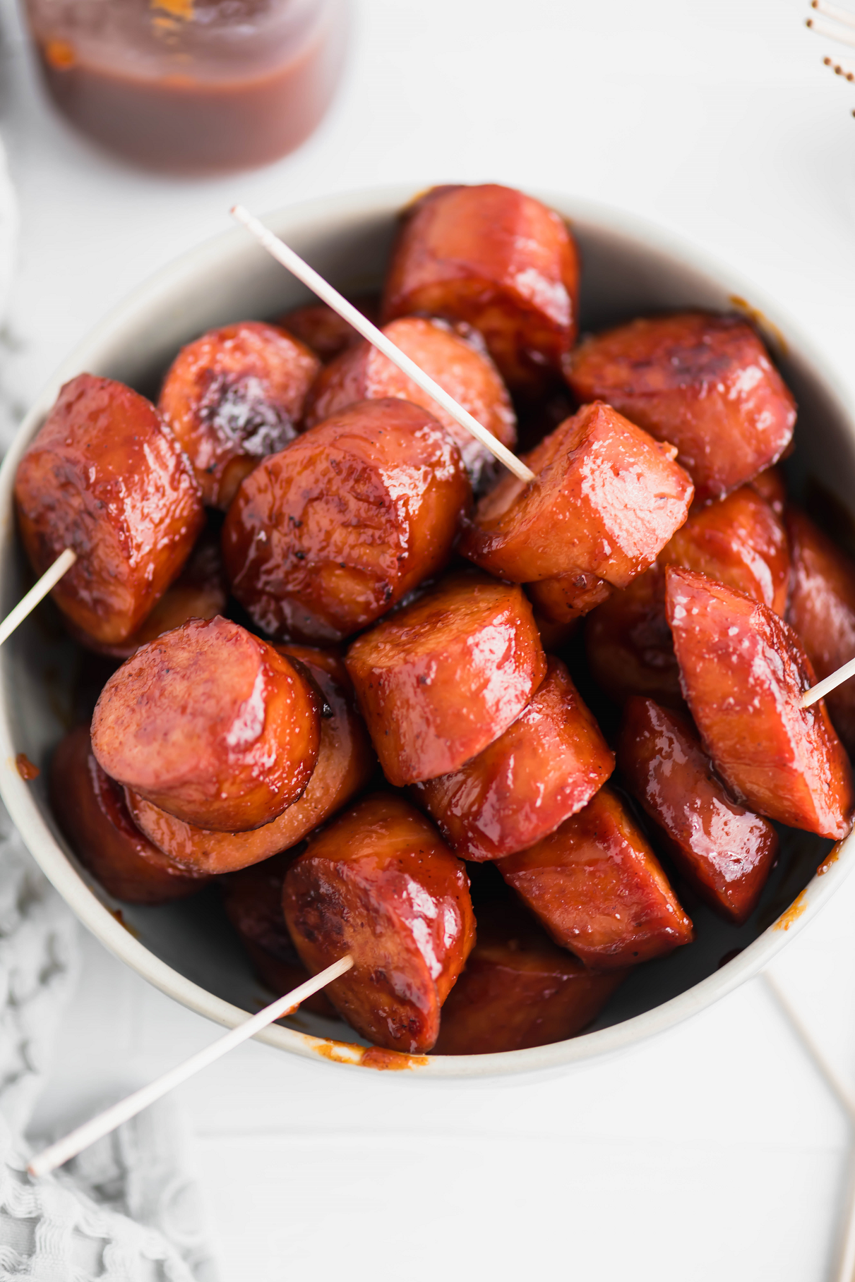 BBQ Kielbasa Bites in a gray bowl with toothpicks in them.