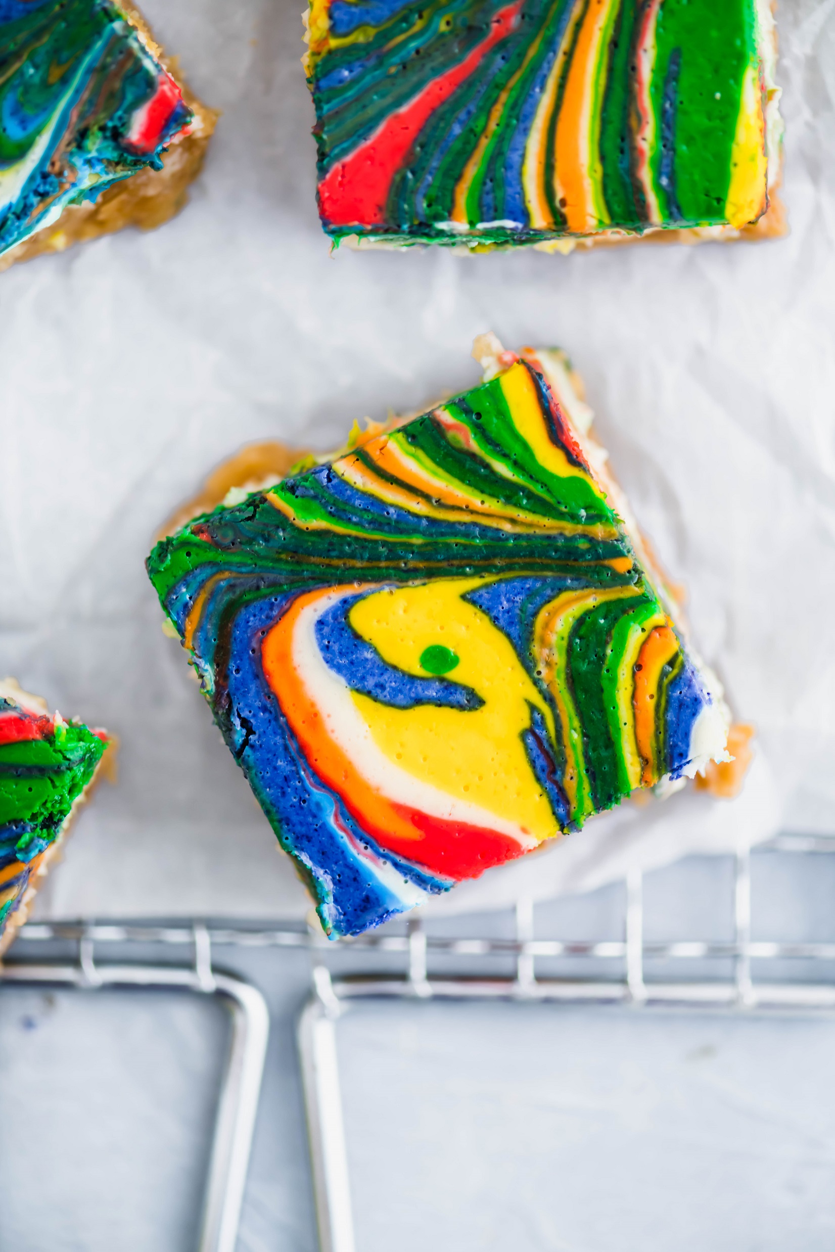 Rainbow Lemon Cheesecake Bars are a fun, festive way to celebrate St. Patrick's Day. Simple cheesecake is colored and swirled to make an adorable dessert.