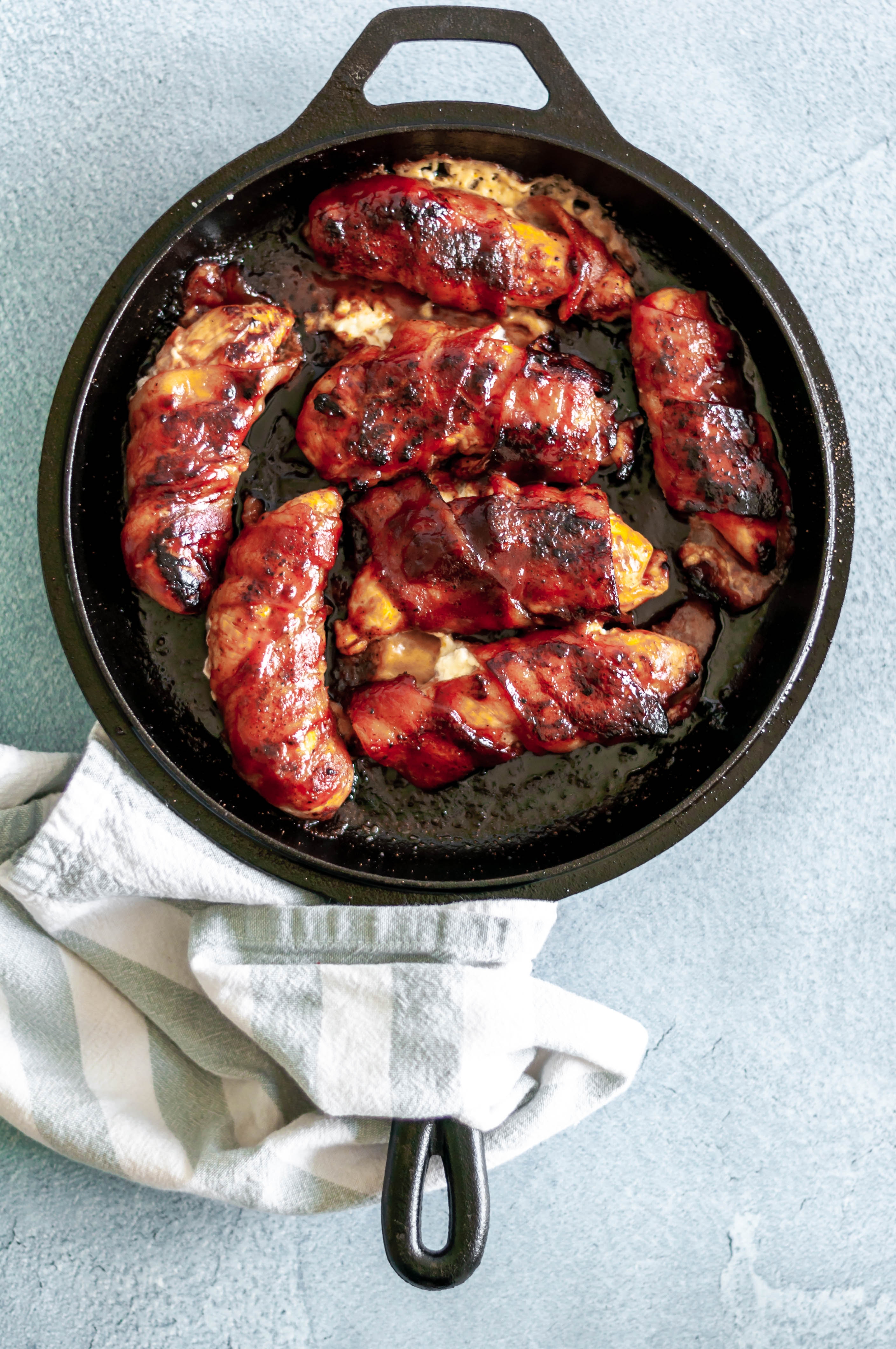 BBQ Bacon Wrapped Chicken smothered in barbecue sauce and stuffed with cream cheese makes the ultimate, flavorful dinner. Simple and delicious.