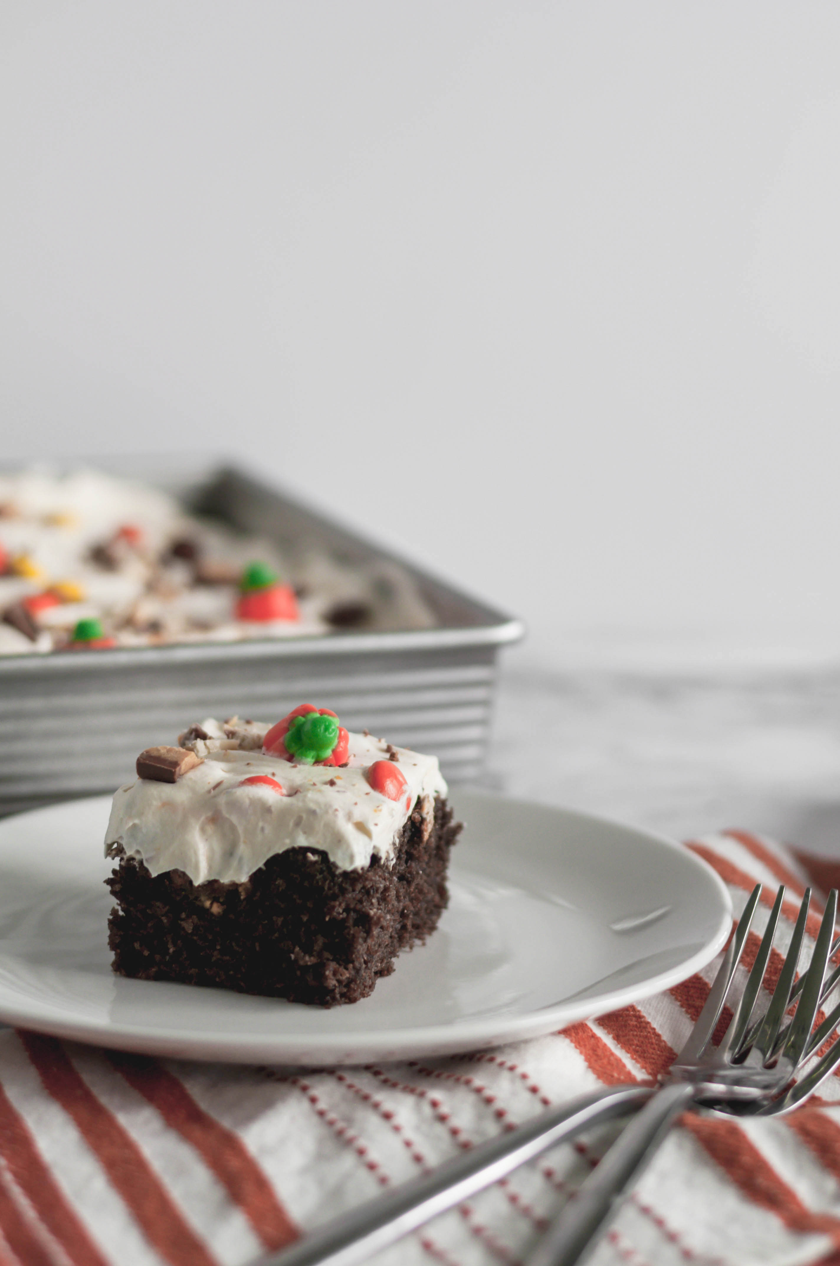 Leftover Halloween Candy Cake is the best way to use up the kids Halloween candy. A simple doctored up cake mix and 4 ingredient frosting for the win.