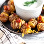 Loaded Mini Hasselback Potatoes are a delicious and adorable party appetizer your holiday needs. Serve with this simple, fresh dill sour cream.