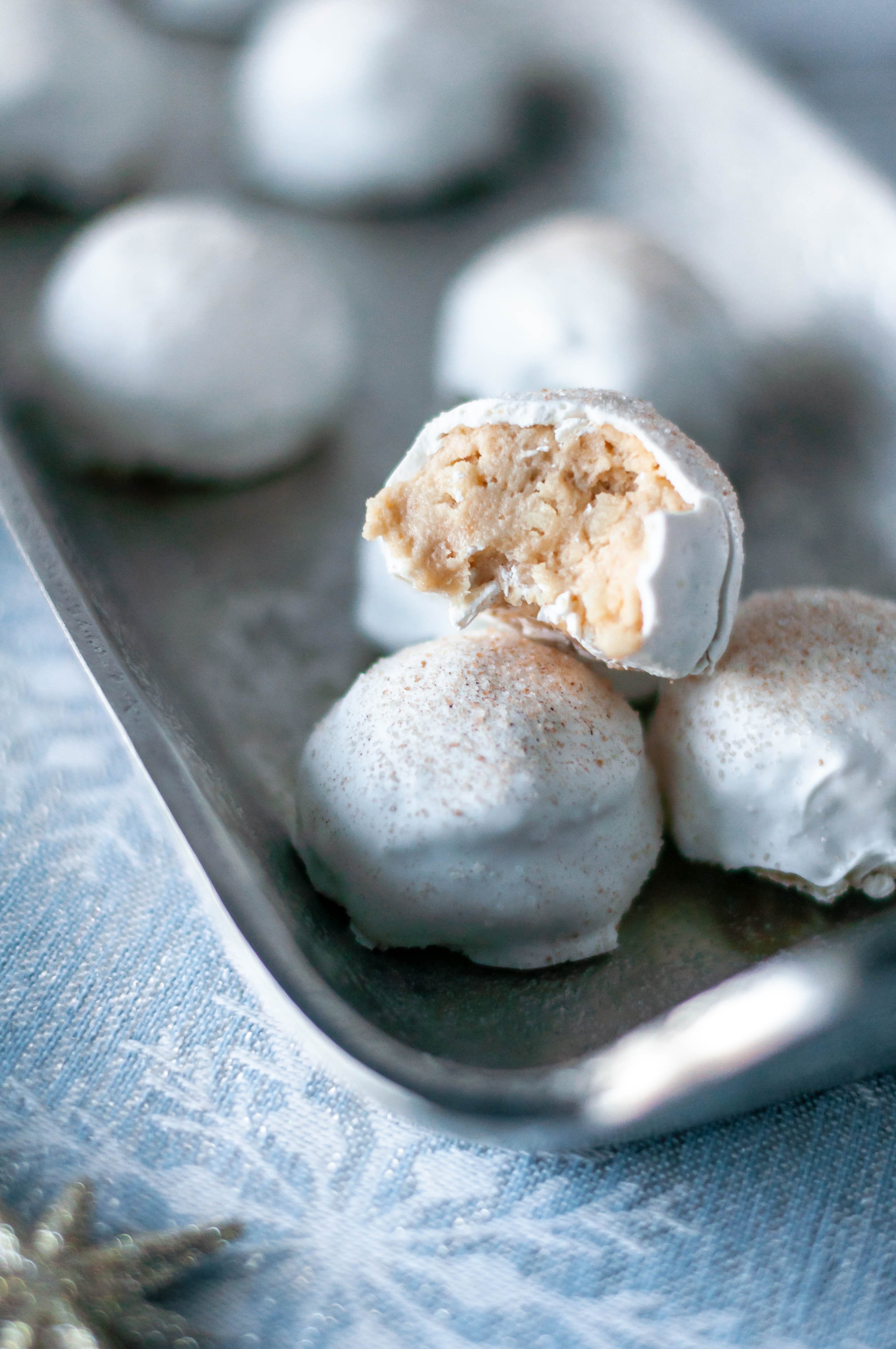 Snickerdoodle Balls are a fun spin on the classic Oreo Ball. Snickerdoodle cookies and cream cheese, dipped in white chocolate with a cinnamon sugar dusting