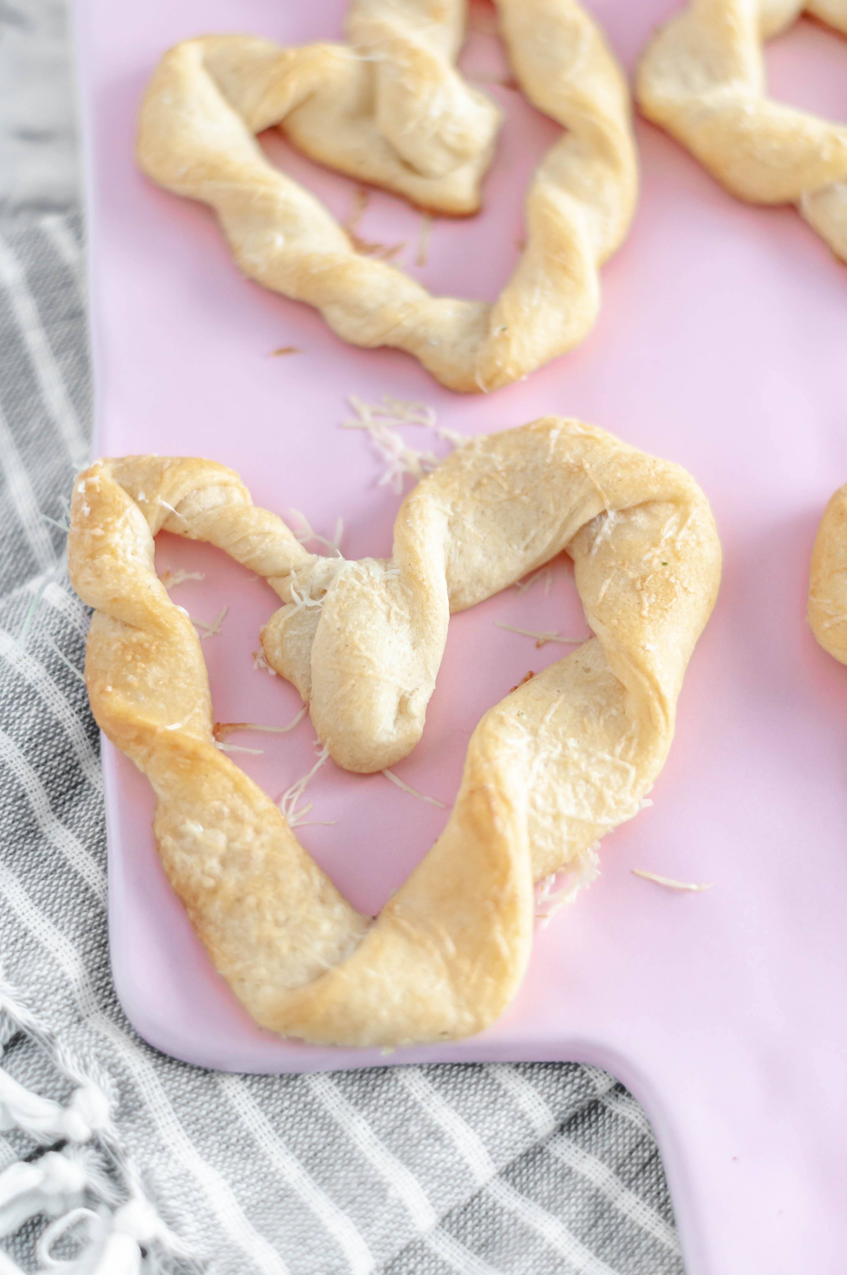 Heart Shaped Breadsticks are a simple way to add some festive flair to Valentines. Store-bought crescent dough & a few simple ingredients are all you need.