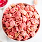 Make your Valentines Day festive with this Coconut Strawberry Puppy Chow. White chocolate, freeze dried strawberries & coconut are such a sweet combination.