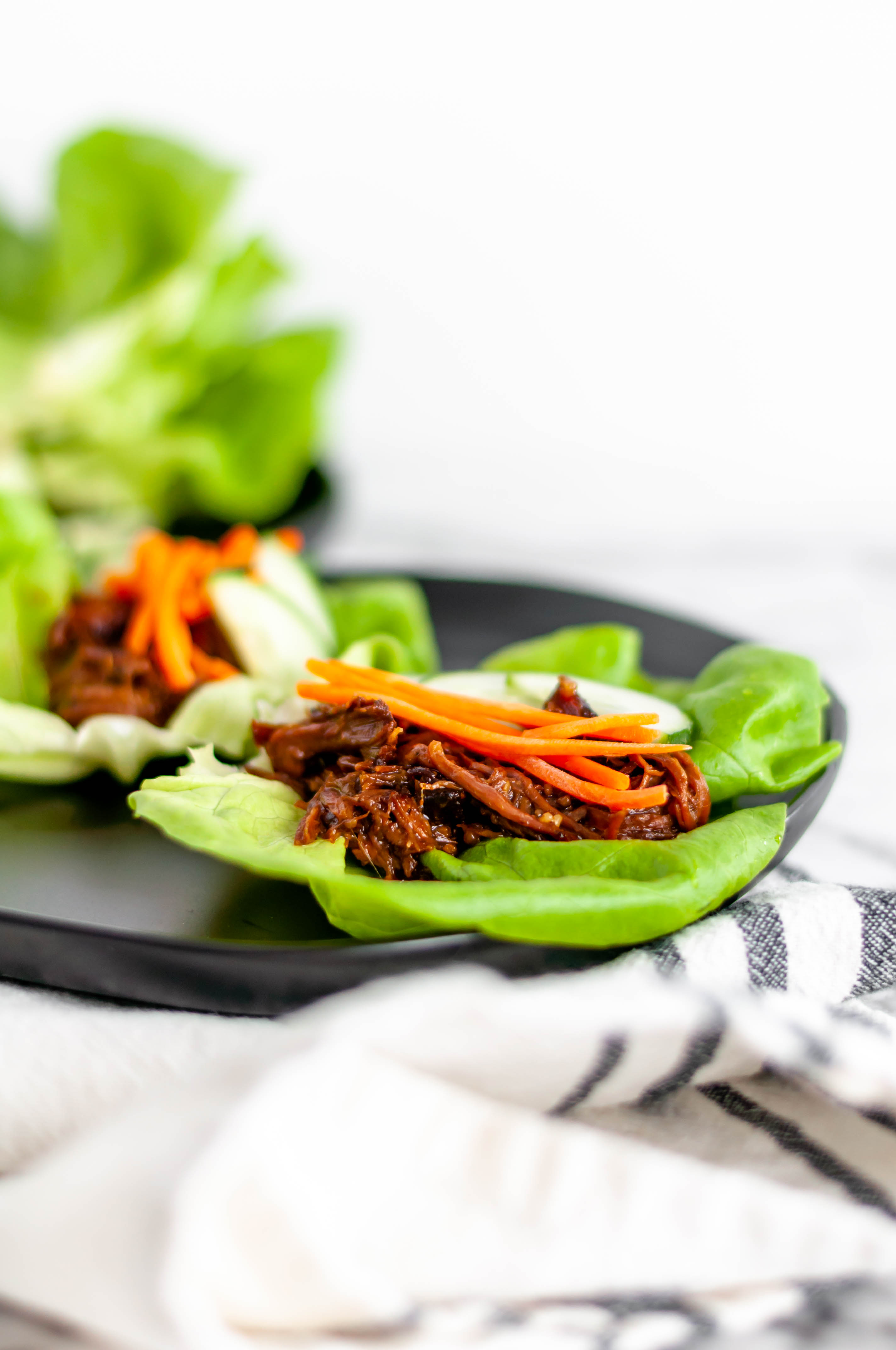 Slow Cooker Asian Beef Lettuce Wraps is the easiest kind of recipe. Everything in the slow cooker then serve in lettuce wraps with crunchy toppings.