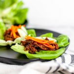 Slow Cooker Asian Beef Lettuce Wraps is the easiest kind of recipe. Everything in the slow cooker then serve in lettuce wraps with crunchy toppings.