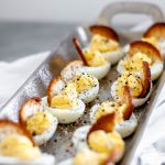 Everything Bagel Deviled Eggs are packed full of flavor. Cream cheese in the egg filling adds an extra creamy texture. Everything bagel seasoning adds tons of flavor. A bagel chip provides a nice crunch to the soft deviled egg.