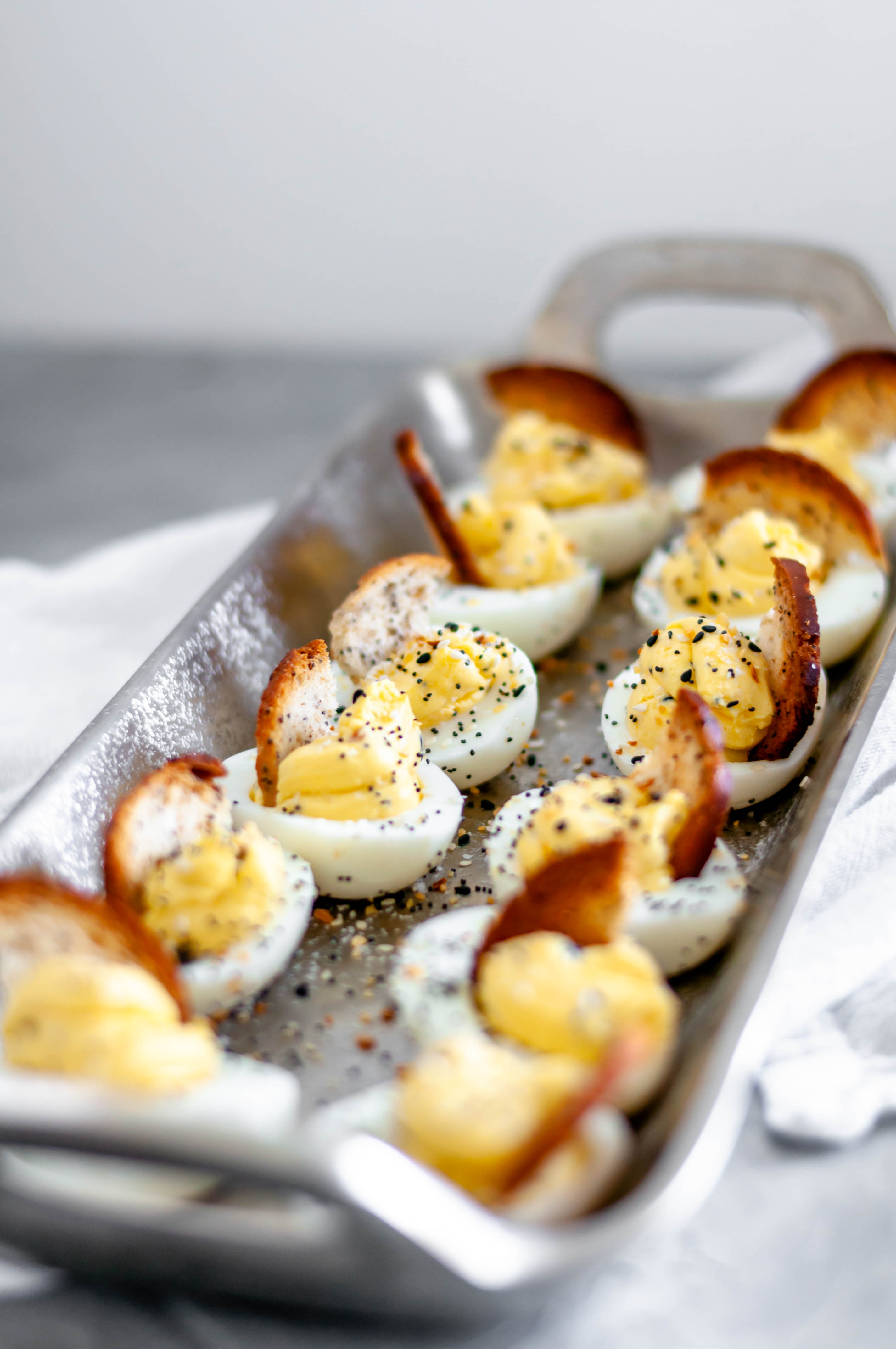 Everything Bagel Deviled Eggs are packed full of flavor. Cream cheese in the egg filling adds an extra creamy texture. Everything bagel seasoning adds tons of flavor. A bagel chip provides a nice crunch to the soft deviled egg.