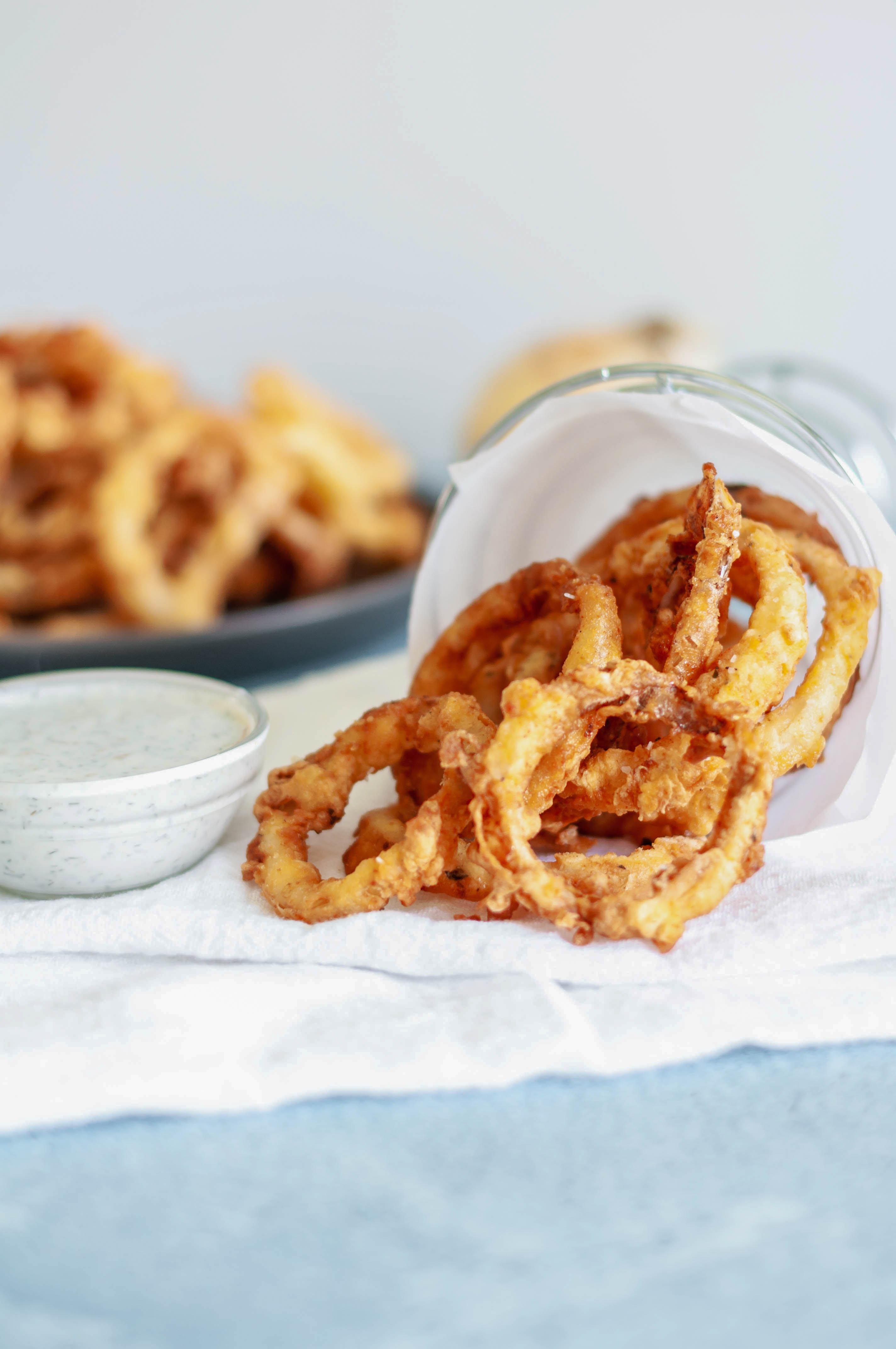These Crispy Onion Rings with Buttermilk Dill Dressing will be the hit of the party. Perfect for appetizers, game day or to go with your burgers.