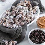 Update your game day snacking with this Puppy Chow Popcorn. Peanut butter and chocolate coated popcorn tossed in powdered sugar. Addiction ahead.
