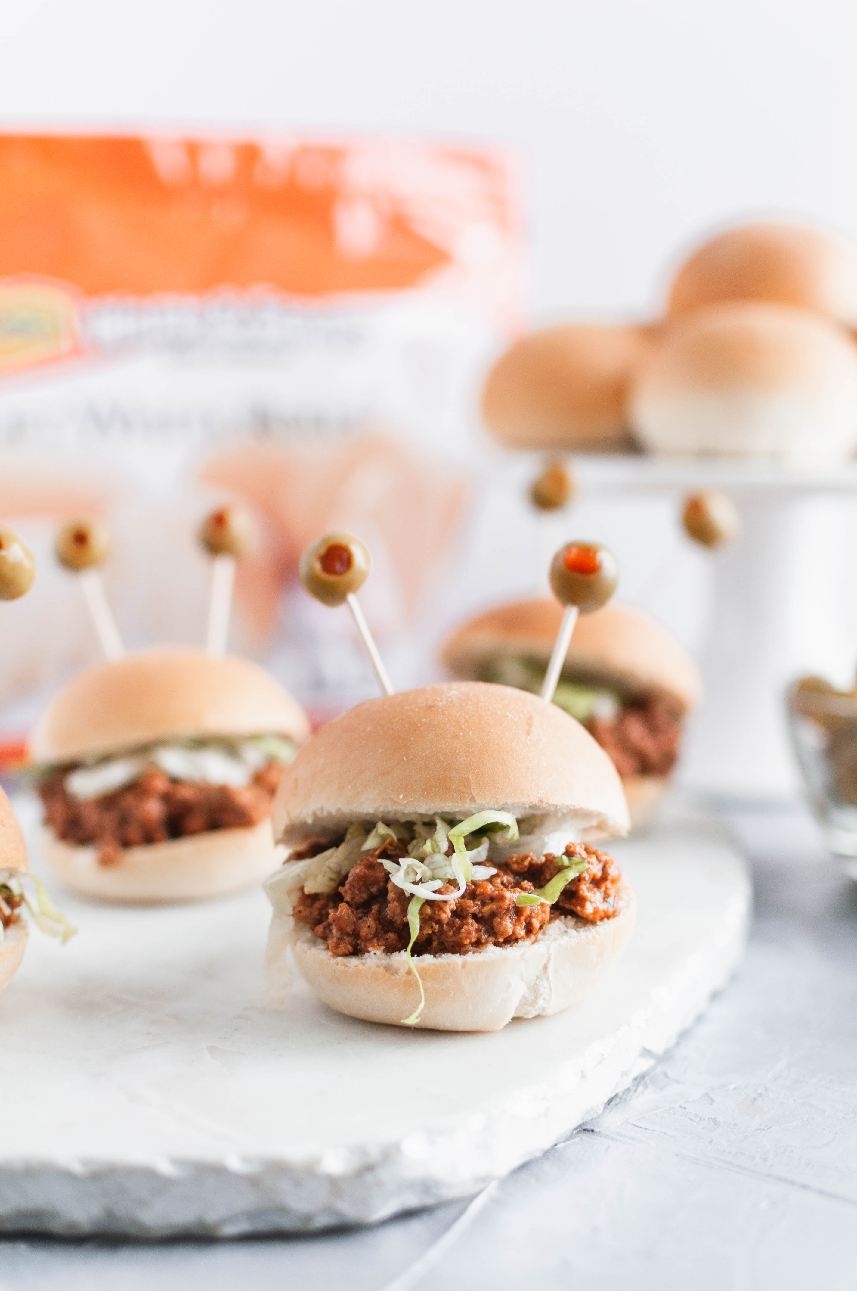 Celebrate Halloween with Rhodes and these spooky Halloween Sliders. Pimento stuffed olives make creepy monster eyes atop these taco sliders.