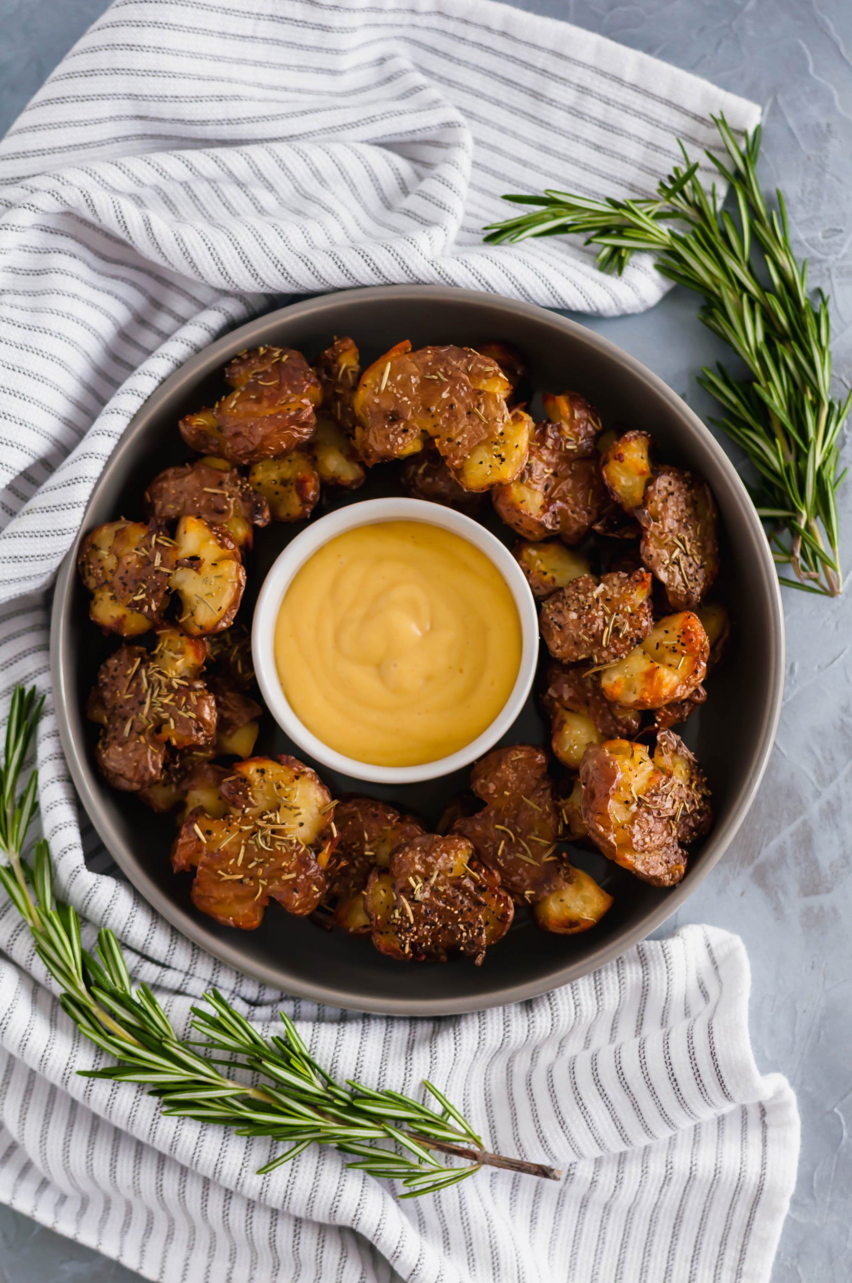 Rosemary Smashed Potatoes are just what you need this holiday season. Fancy enough for guests but easy enough for weeknights. Super crispy and flavorful.