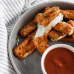 These Mozzarella Sticks with Pretzel Crumbs are the ultimate Super Bowl appetizer. Mozzarella cheese sticks covered in pretzels crumbs and fried to golden brown. Just look at that cheese pull.