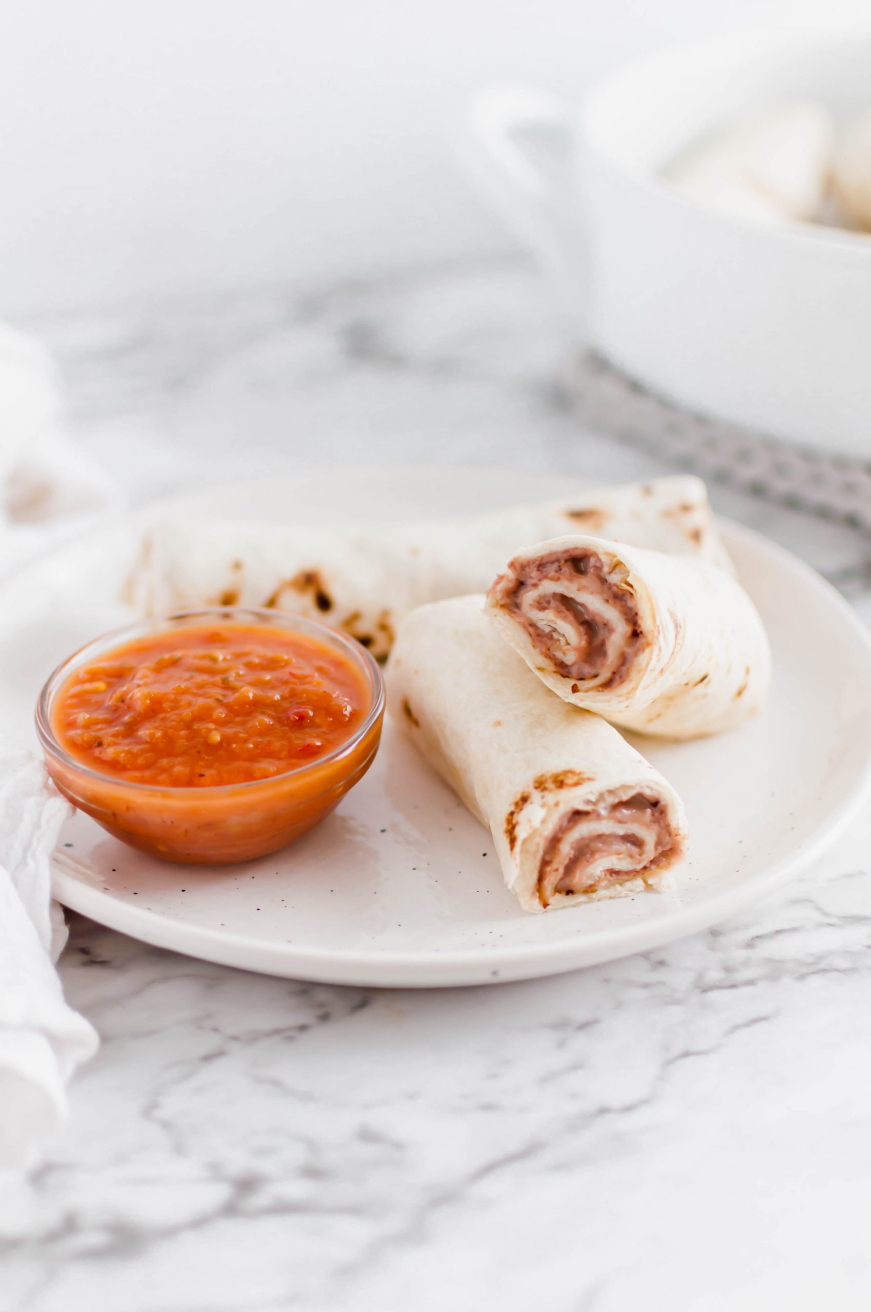 These Bean and Cheese Burritos are a great meal prep or easy dinner option. Freezer friendly with directions included.