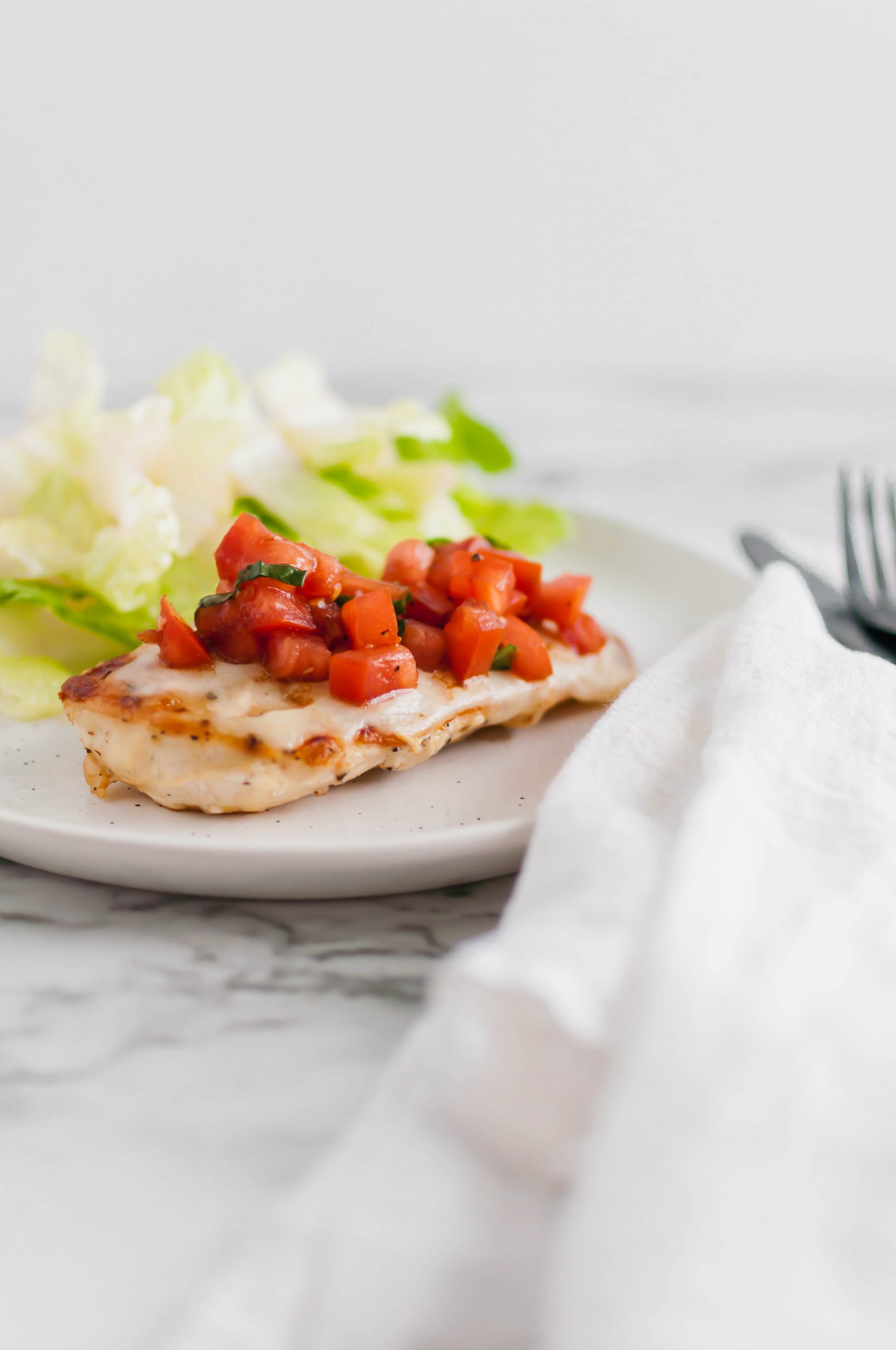 This Bruschetta Chicken comes together in less than 30 minutes for the perfect simple, healthy and fresh dinner. Perfectly seared chicken, lots of melted mozzarella and a super simple homemade bruschetta.