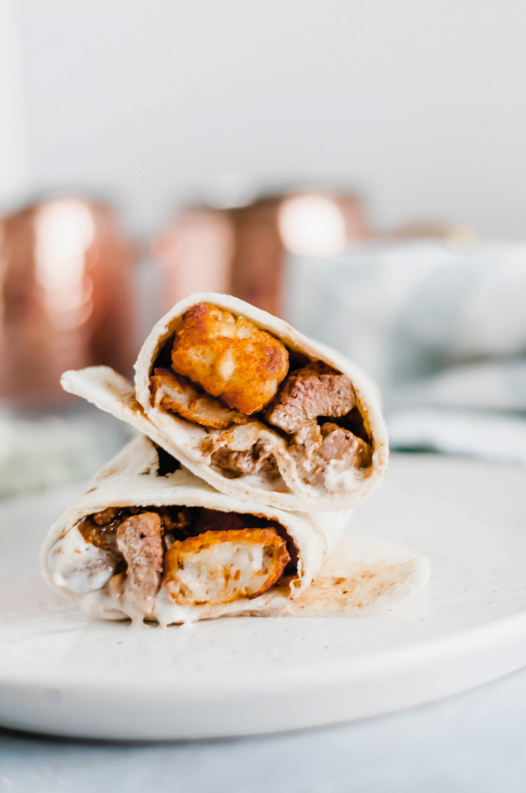 This Steak and Potato Burrito is stuffed with tender seared steak, crispy tater tots, blue cheese dressing and a drizzle of steak sauce. The perfect meal any time of the day.