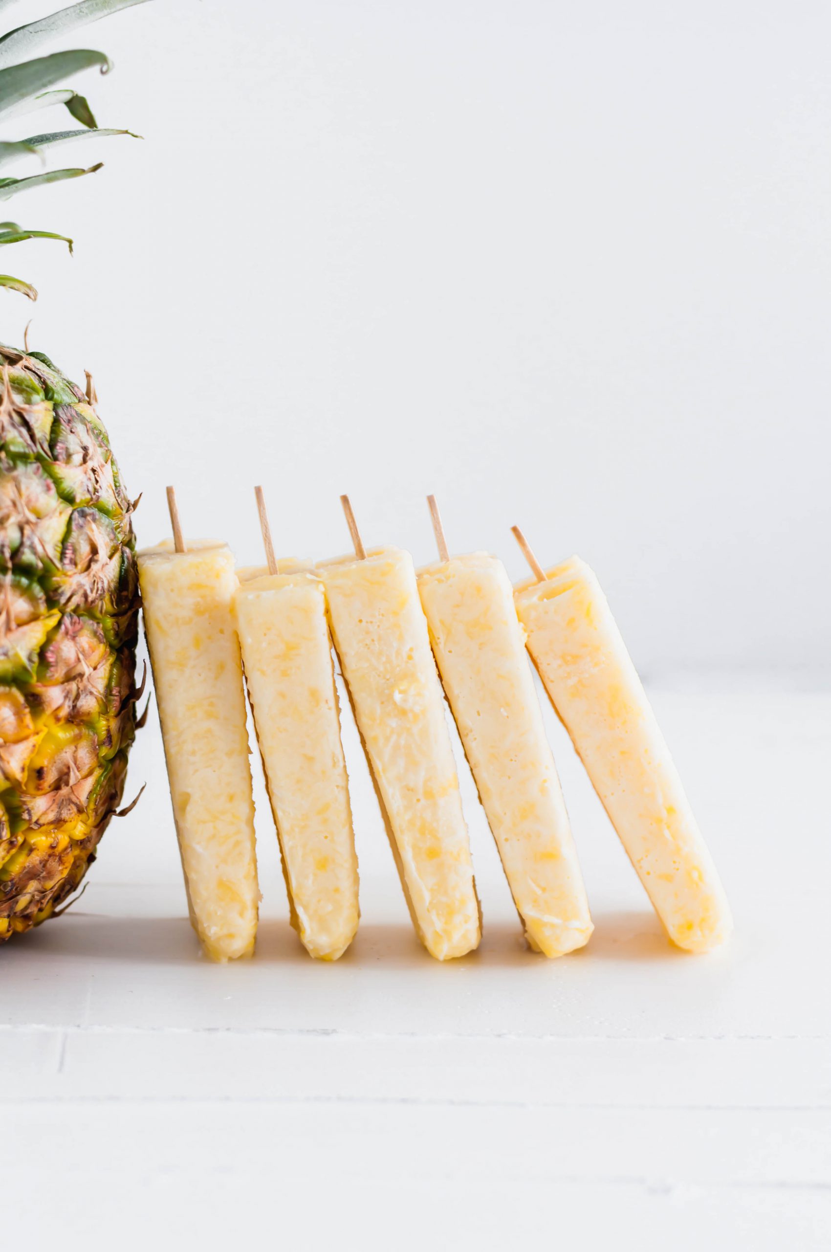 These Pina Colada Popsicles will be the treat of summer. Creamy coconut and sweet pineapple make a simple, delicious dessert that tastes just like the classic drink (without the booze).