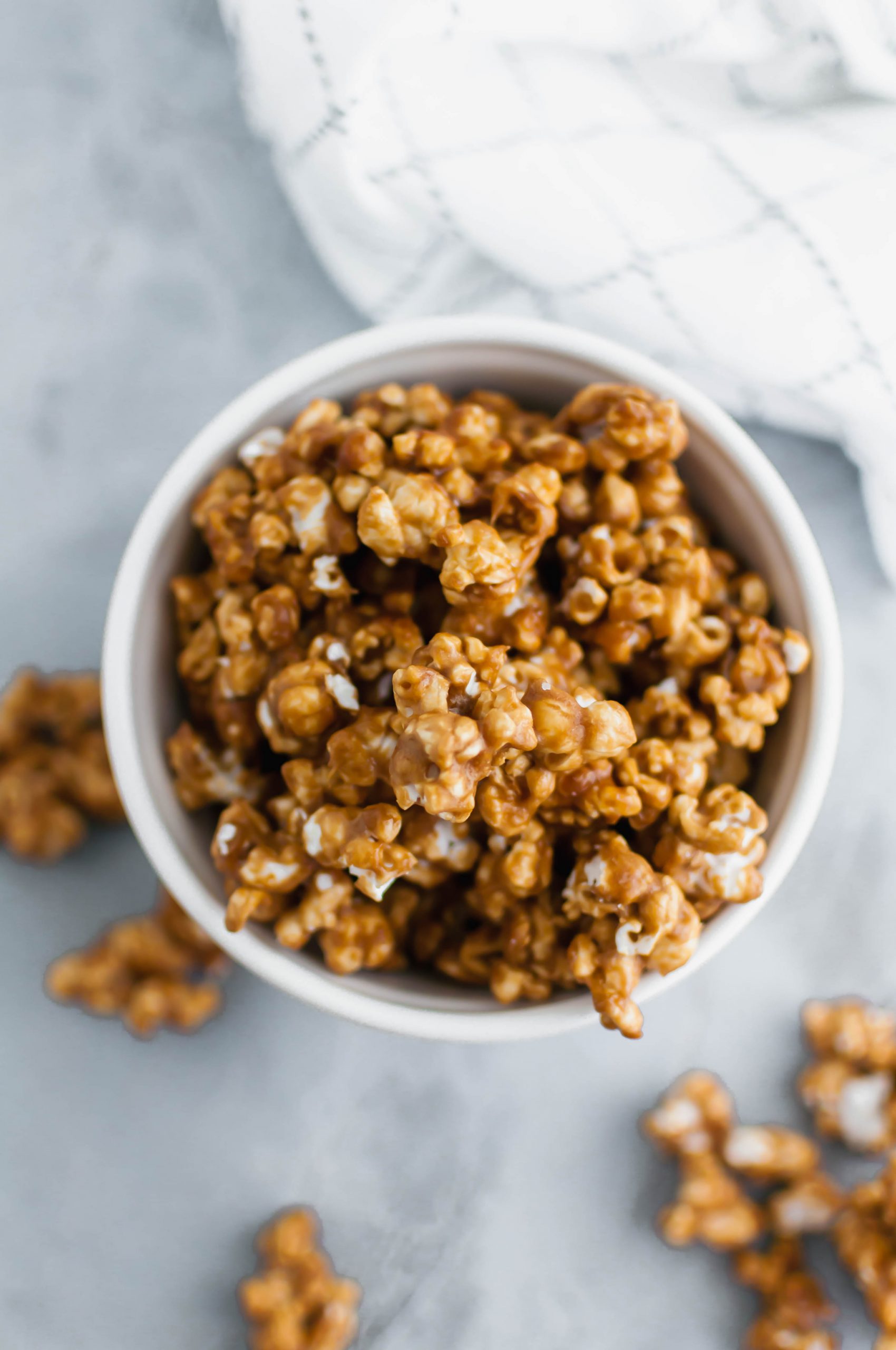 Salted caramel popcorn is the perfect addition to a party or movie night. It features a simple homemade caramel sauce, freshly popped popcorn and a hearty sprinkle of coarse salt.