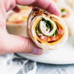 These Turkey Club Pinwheels turn the classic sandwich into a fun, bite-size appetizer. Great for parties or a fun lunch option. Spiced mayo, sharp cheddar cheese, deli turkey, bacon, lettuce and tomato make up these delicious pinwheels.