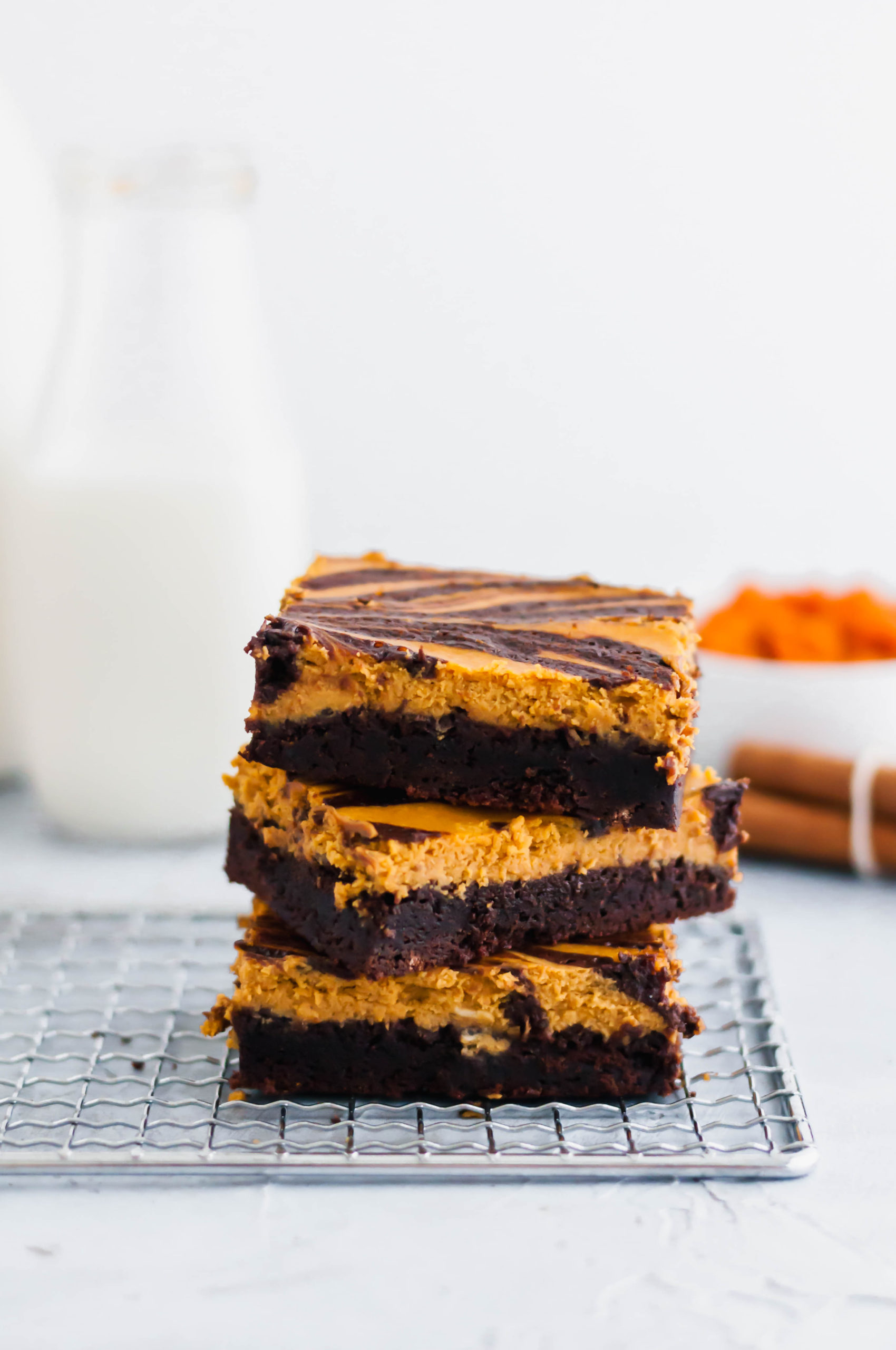 These Pumpkin Cheesecake Brownies are a must try dessert this fall. Thick, fudgy one pot brownies topped with a simple, delicious spiced pumpkin cheesecake.