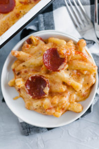 Two American favorites combine to make the most glorious Pizza Macaroni and Cheese. Creamy, cheesy pasta topped with pizza sauce, pepperoni and more cheese. Customize it and use your favorite toppings.