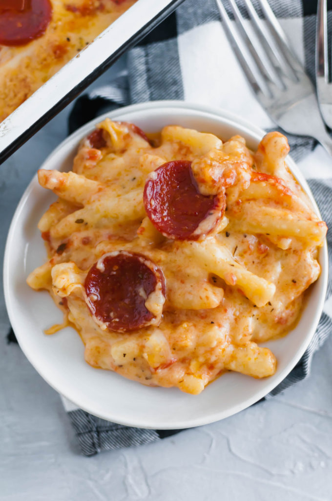 Two American favorites combine to make the most glorious Pizza Macaroni and Cheese. Creamy, cheesy pasta topped with pizza sauce, pepperoni and more cheese. Customize it and use your favorite toppings.