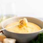 Three Cheese Fondue is perfect for the holidays. Creamy smoked gouda, sharp cheddar and fresh parmesan combine with garlic and white wine for a super fun appetizer or dinner. Use bread, steamed veggies, chicken and steak as dippers.