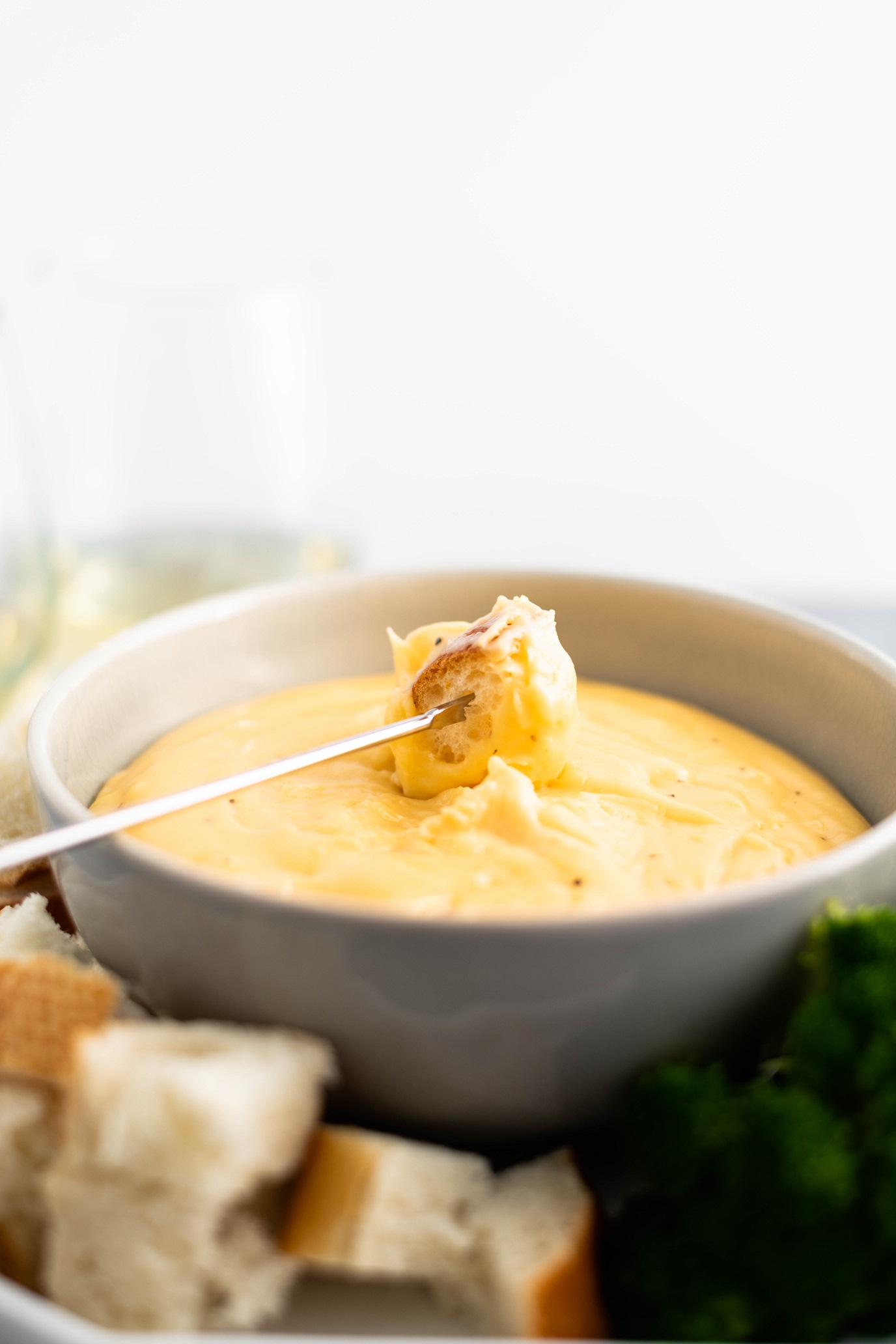 Three Cheese Fondue is perfect for the holidays. Creamy smoked gouda, sharp cheddar and fresh parmesan combine with garlic and white wine for a super fun appetizer or dinner. Use bread, steamed veggies, chicken and steak as dippers.