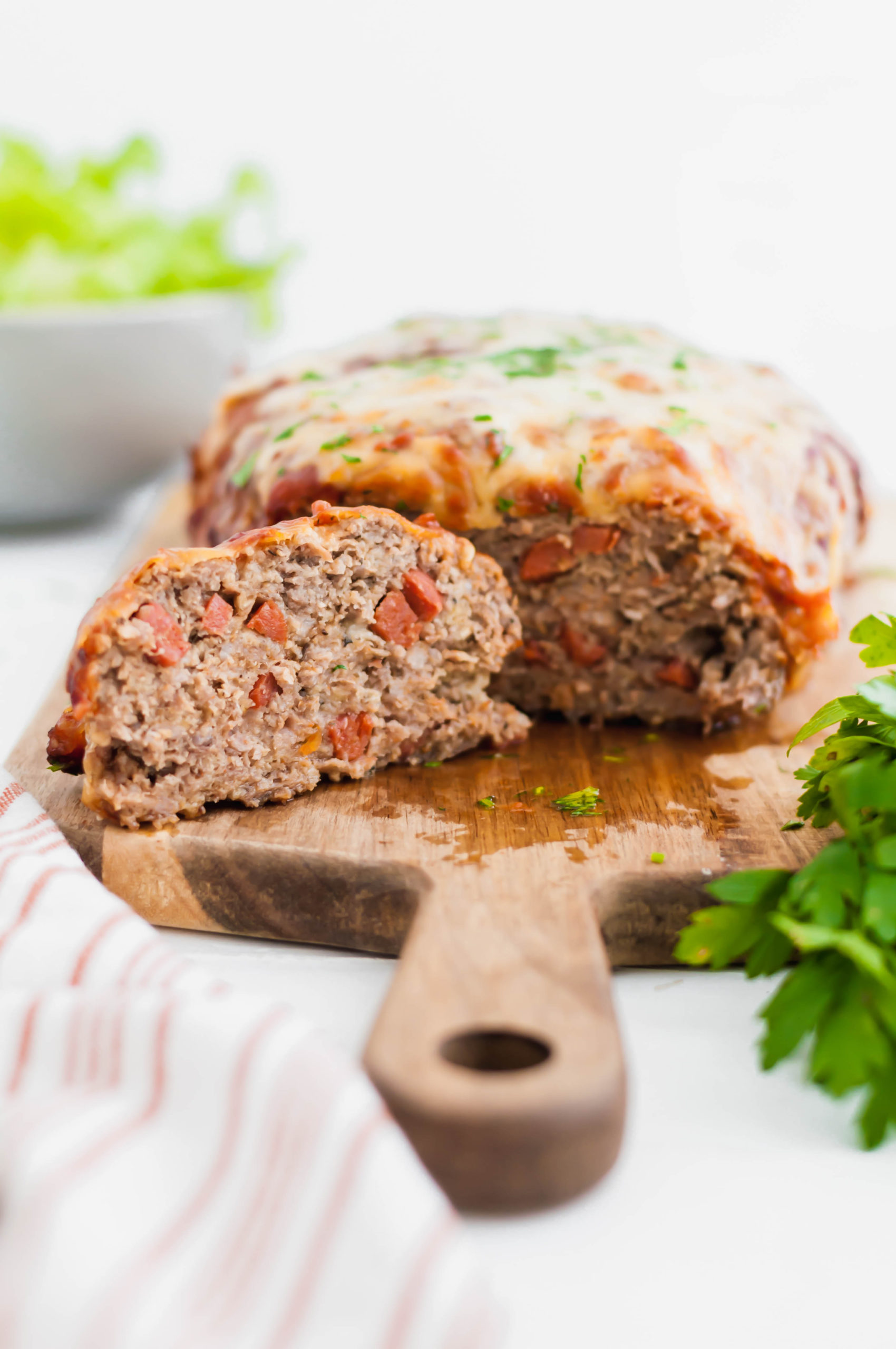 Two dinnertime favorite collide with this Pizza Meatloaf. Pizza ingredients throughout the meatloaf and on top puts that pizza flavor over the top.