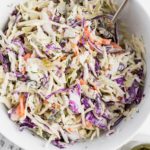 Change up your classic coleslaw with this Dill Pickle Coleslaw. Creamy dressing spiked with pickle juice, chopped pickles and fresh dill brings all the pickle flavor.